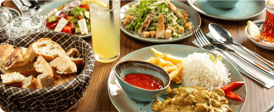 Assorted dishes on a table with drinks.