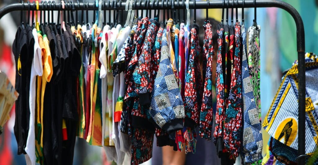 Colorful shirts hanging on a clothing rack.