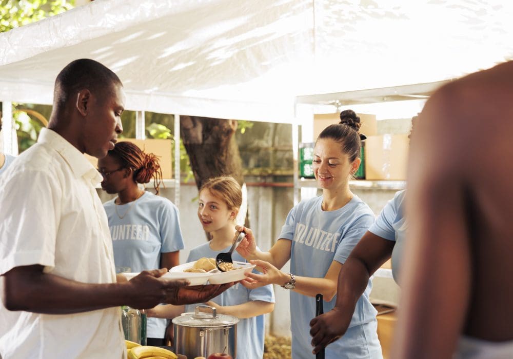 Volunteers serving food at a community event.
