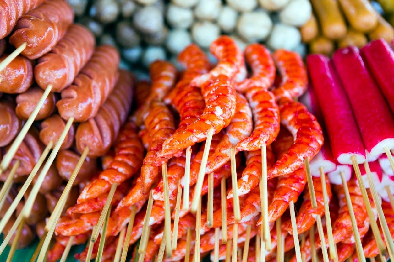 Skewered meats and seafood on display.