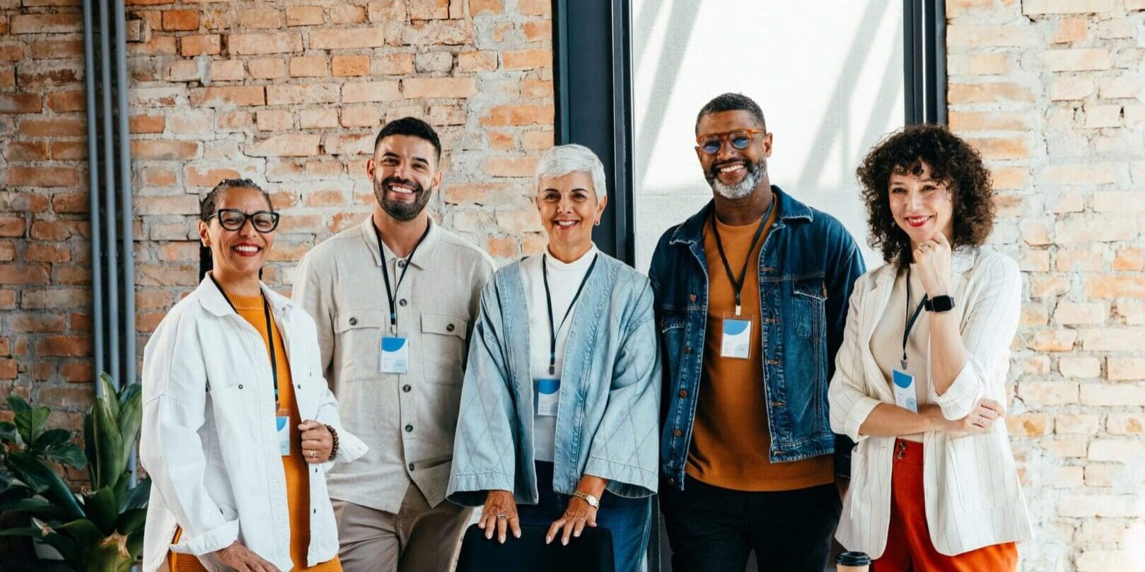 A diverse group of professionals standing together in an office.
