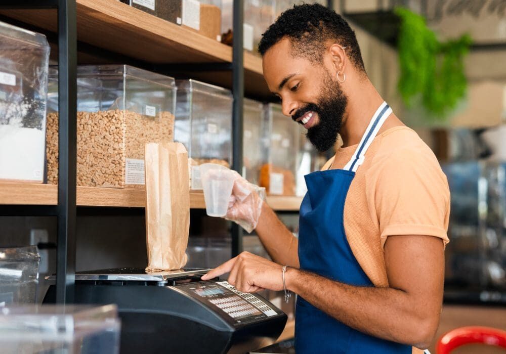 Man weighing food in a grocery store.